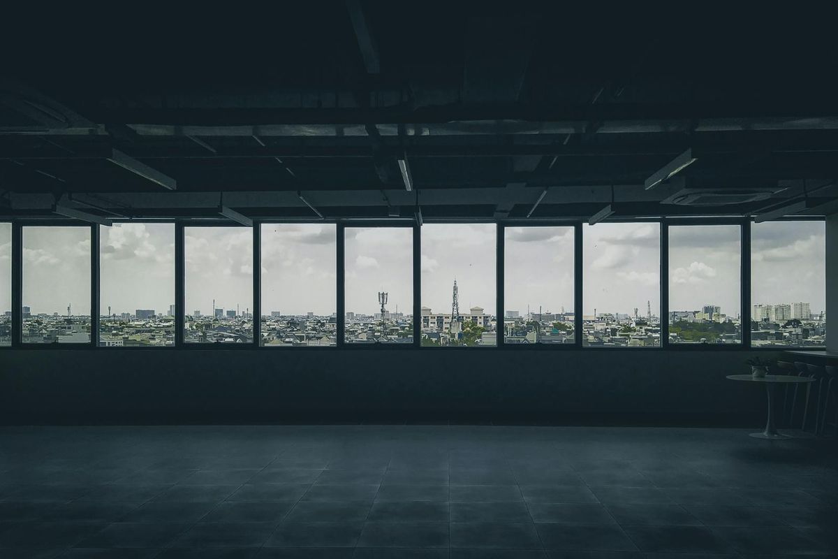 Wide view of a person exercising in a sunny minimalist loft